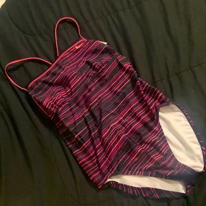 Nike one piece striped with purple, pink, fuchsia.